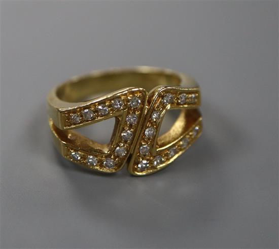 A modern 18ct gold and diamond set stylised buckle ring, size M, gross 7.8 grams.